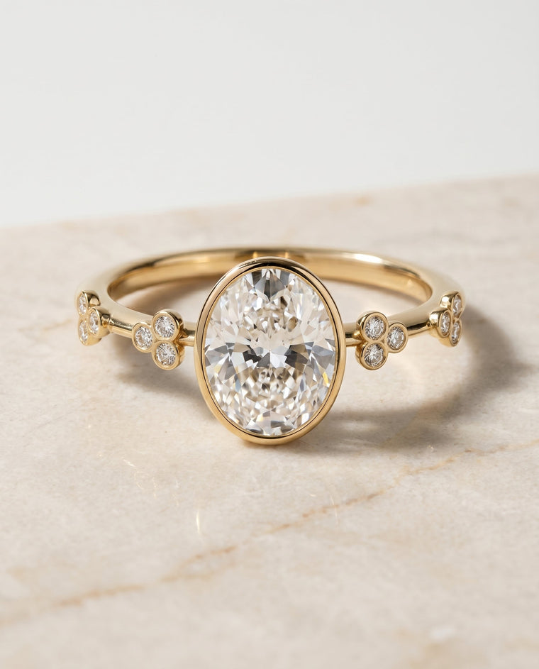 The Miley Select Clover Bezel Accent Solitaire Oval Lab Diamond Engagement Ring in 18K Yellow Gold
