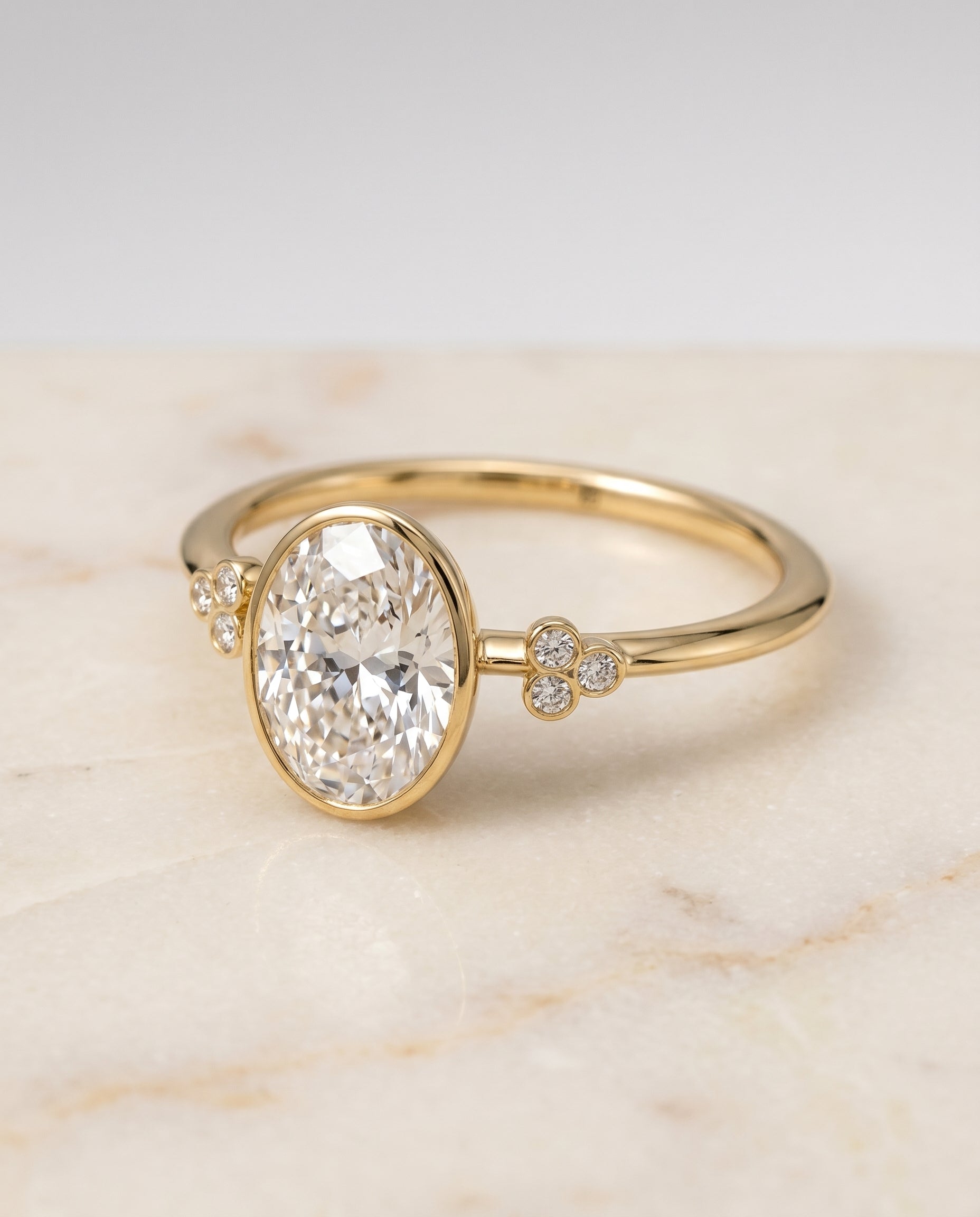 Selena Select Clover Bezel Accent Solitaire Oval Lab Diamond Engagement Ring in 18K Yellow Gold, alternate angle | RockHer