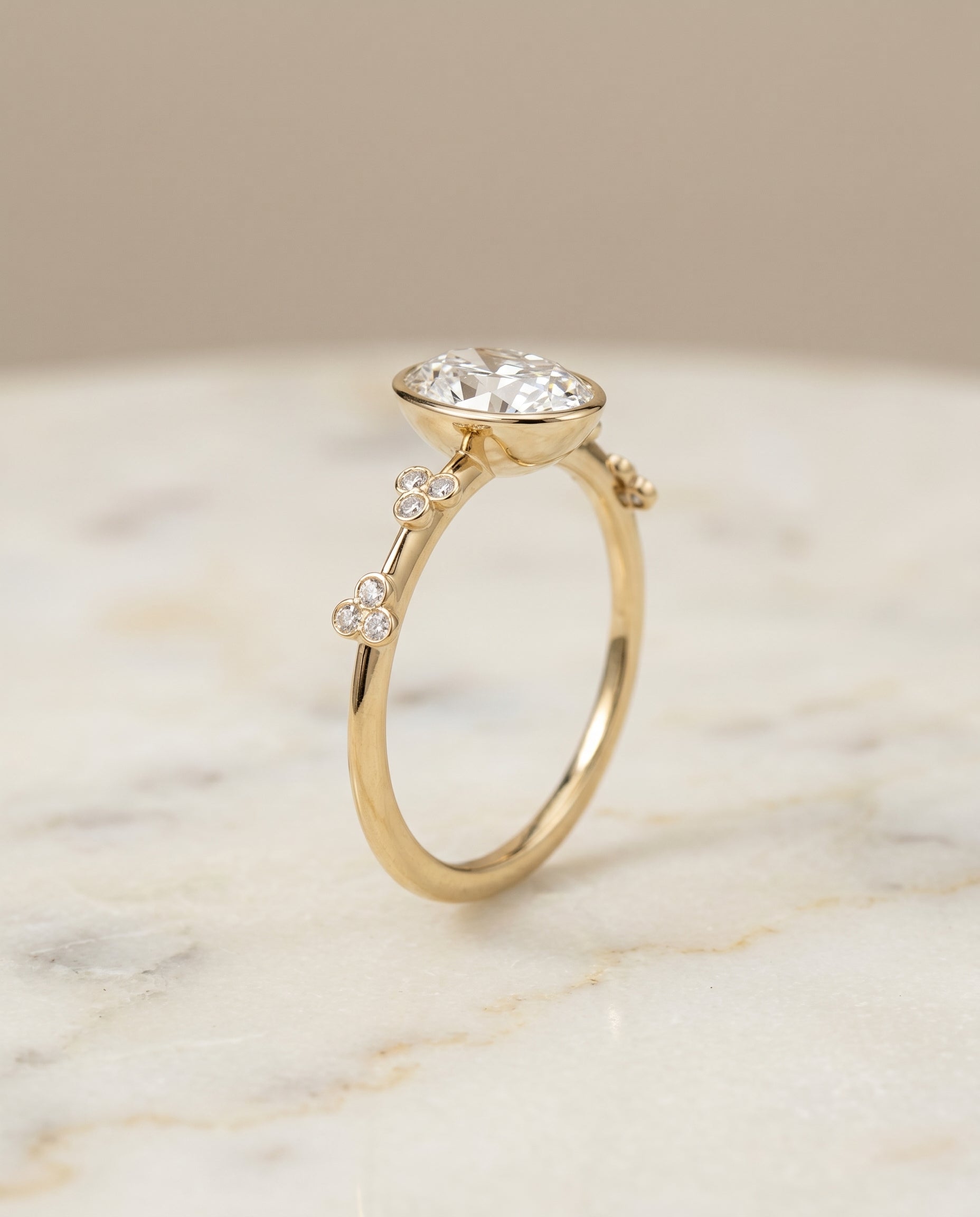 Clover Bezel Accent Solitaire styling on The Miley oval engagement ring setting | RockHer