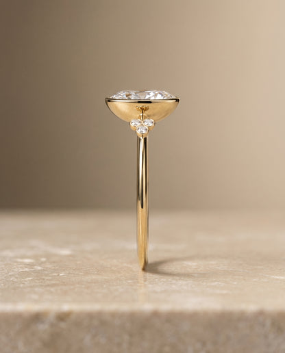 The Selena Clover Bezel Accent Solitaire Oval Engagement Ring Setting in 18K Yellow Gold