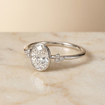 The Selena Clover Bezel Accent Solitaire Oval Engagement Ring Setting in 18K White Gold