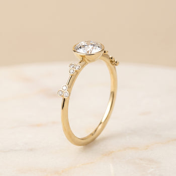 The Miley Clover Bezel Accent Solitaire Round Engagement Ring Setting in 18K Yellow Gold