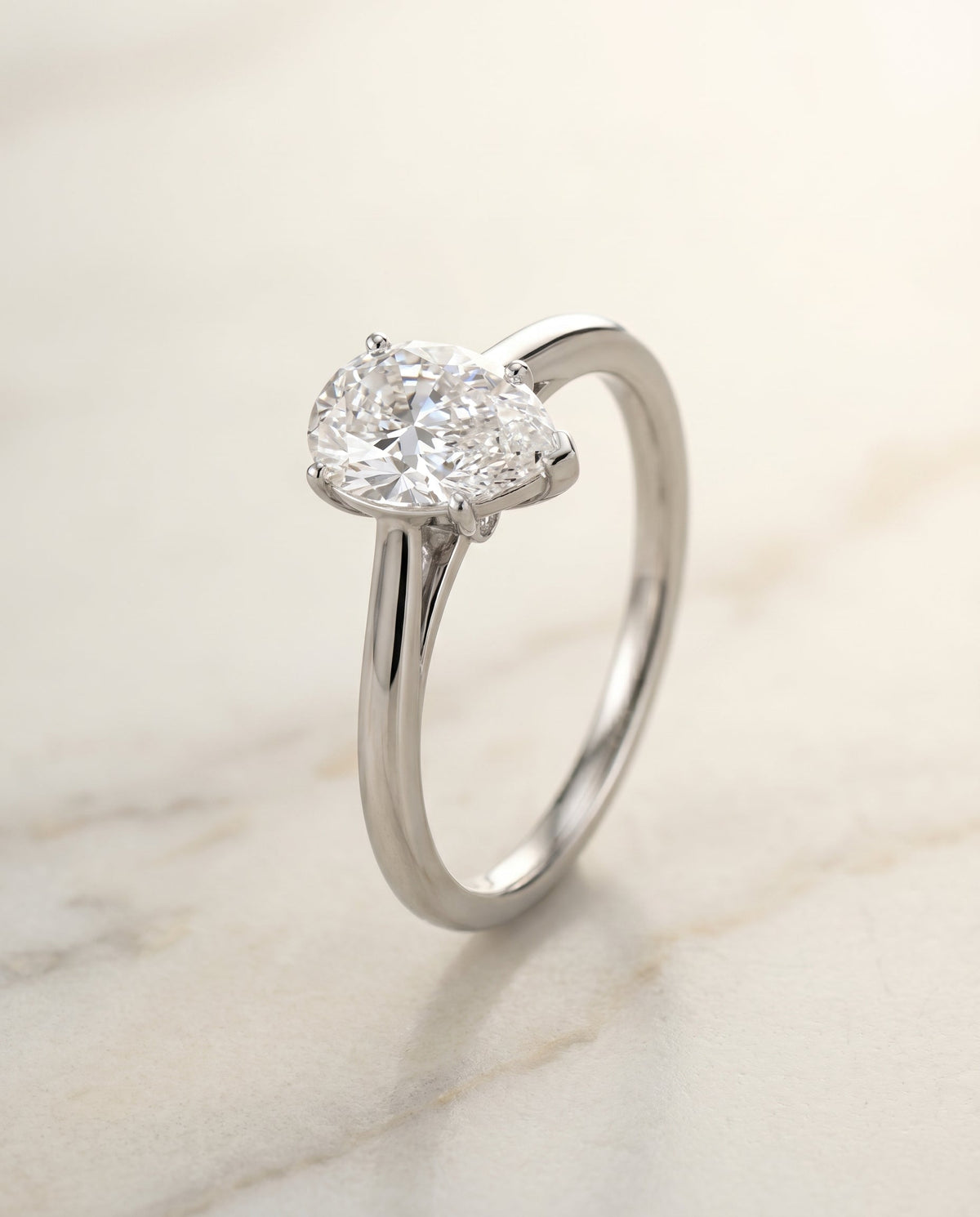 Valerie Select Comfort Fit Secret Stone Solitaire Ps Pear Lab Diamond Engagement Ring in Platinum, front view | RockHer
