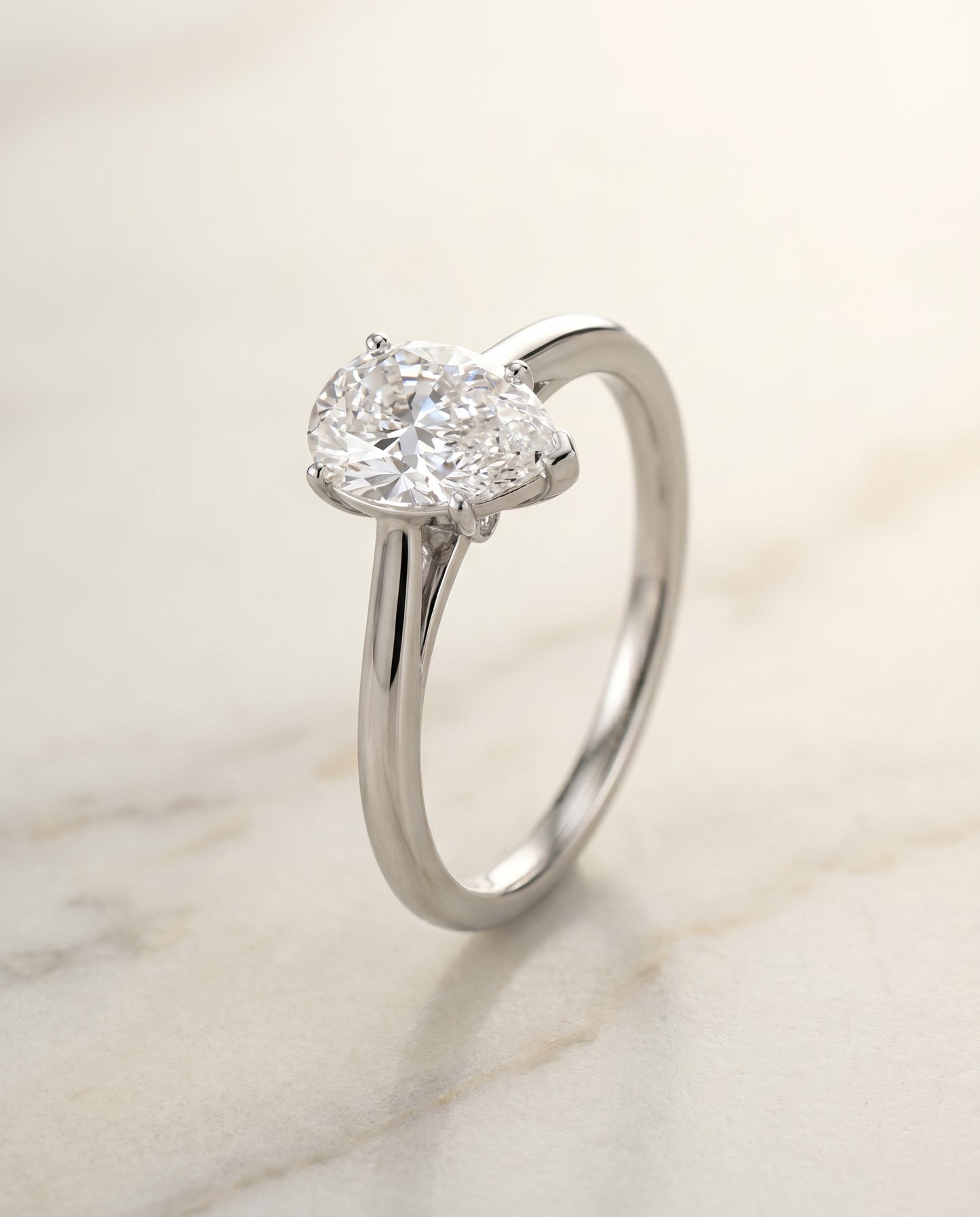 Comfort Fit Secret Stone Solitaire Pear Shape, in Platinum – front view | RockHer