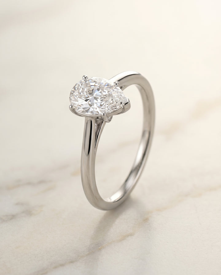 Comfort Fit Secret Stone Solitaire Pear Shape, in Platinum – front view | RockHer