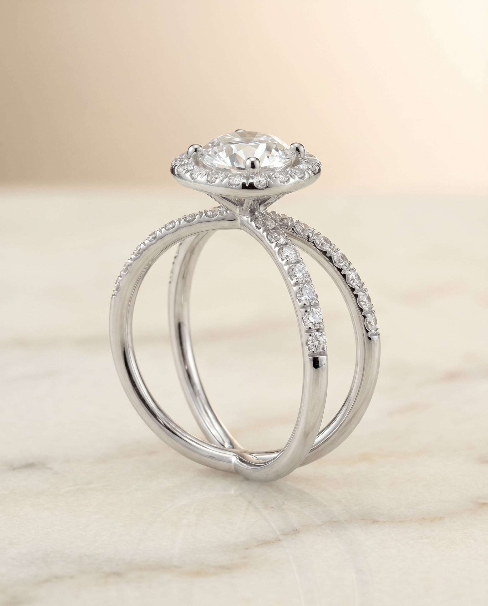 The Joan crossover pavé halo engagement ring setting, shown in Platinum | RockHer