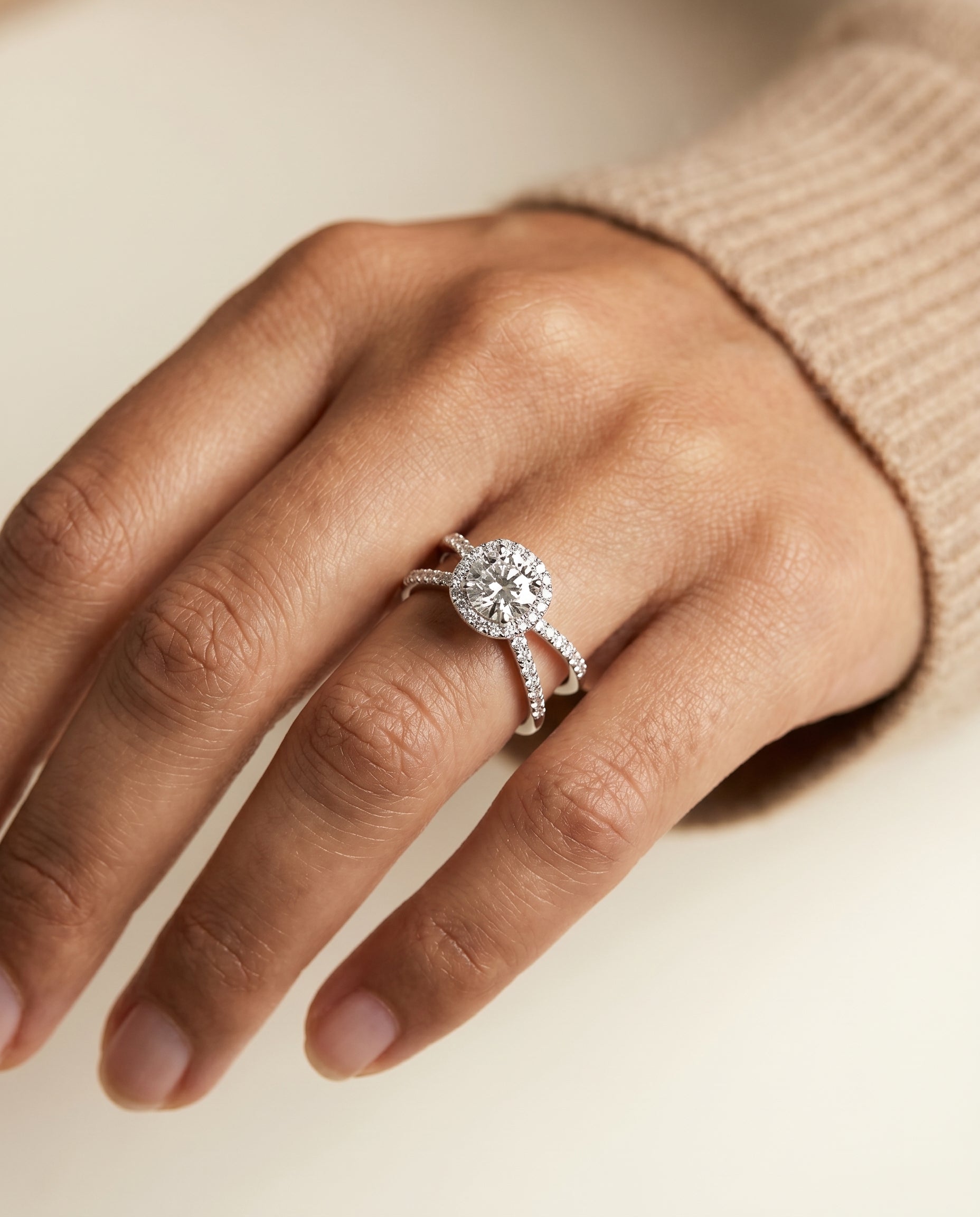 Joan Select Crossover Pavé Halo Round Lab Diamond Engagement Ring in Platinum, shown on hand, angled | RockHer