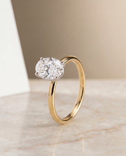 The Cyndi Curved Hidden Halo Solitaire Oval Engagement Ring Setting in 18K Yellow Gold