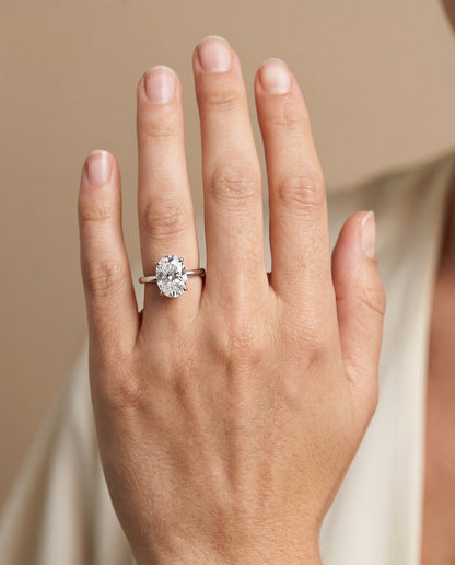 Cyndi Select Curved Hidden Halo Solitaire Oval Lab Diamond Engagement Ring in 14K White Gold, shown on hand | RockHer