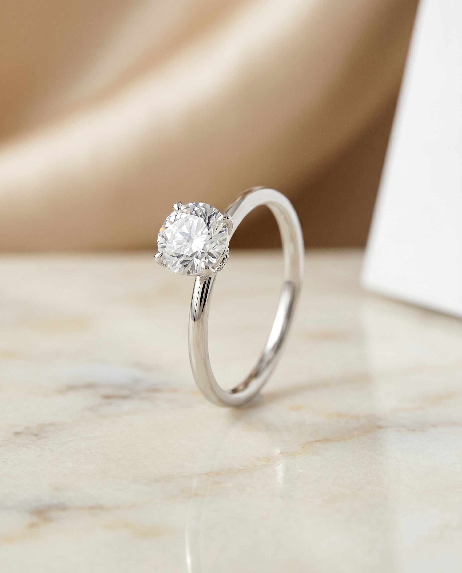 Curved Hidden Halo Solitaire styling on The Cyndi round engagement ring setting | RockHer