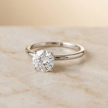 The Cyndi Curved Hidden Halo Solitaire Round Engagement Ring Setting in 18K White Gold