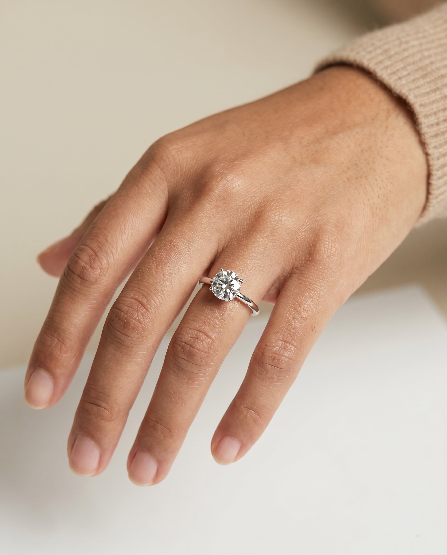 Cyndi Select Curved Hidden Halo Solitaire Round Lab Diamond Engagement Ring in Platinum, shown on hand | RockHer