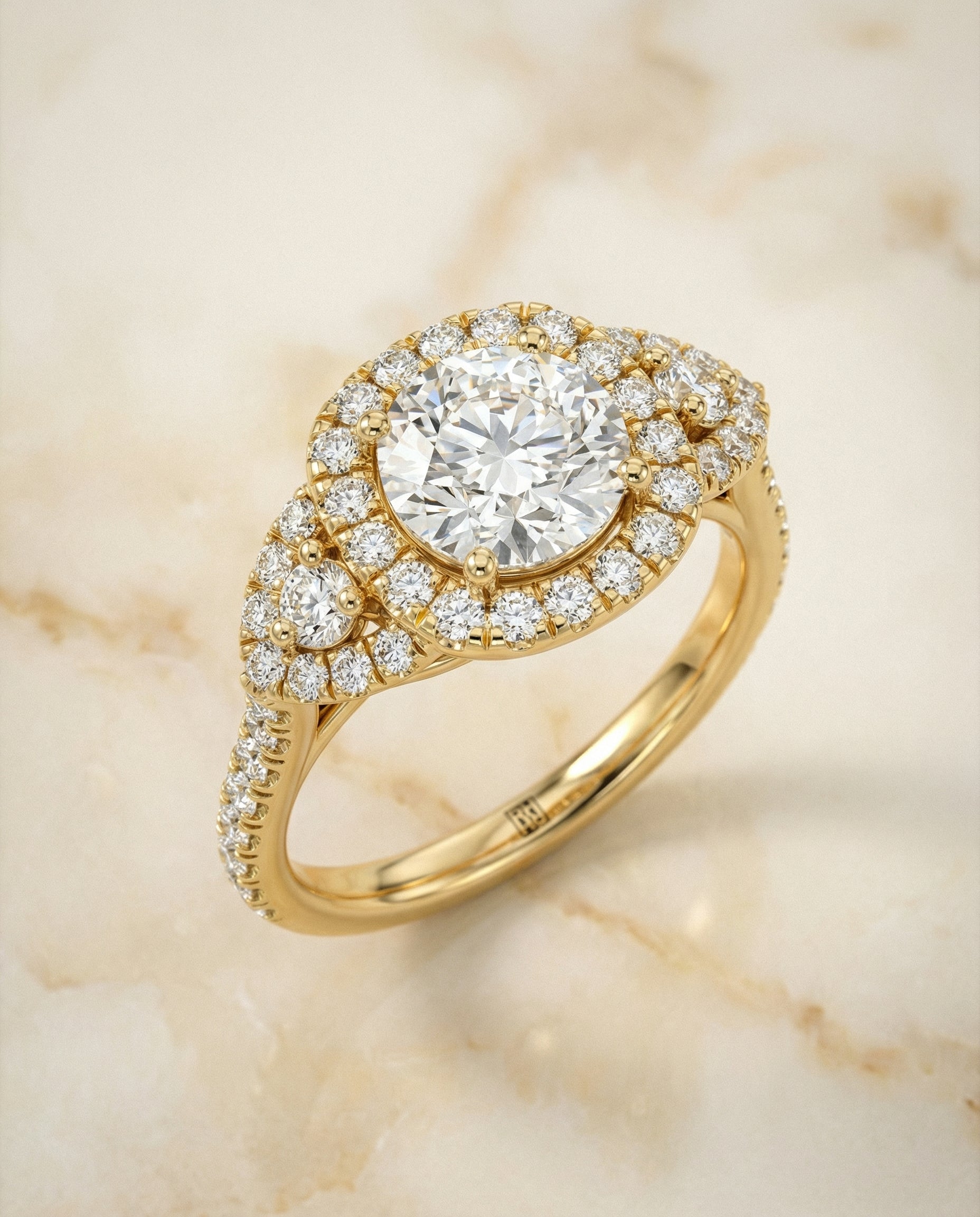 Round Brilliant, Delicate Three Stone Halo, in 18K Yellow Gold, pave setting – angled view | RockHer