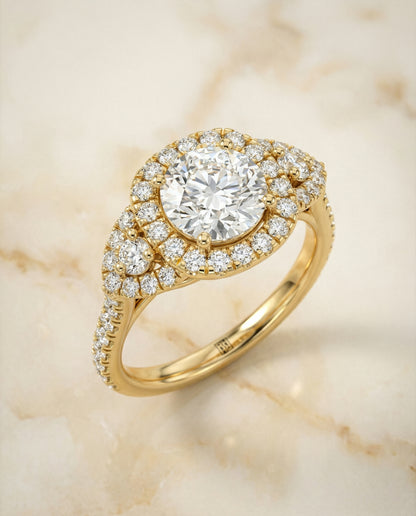 Round Brilliant, Delicate Three Stone Halo, in 18K Yellow Gold, pave setting – angled view | RockHer