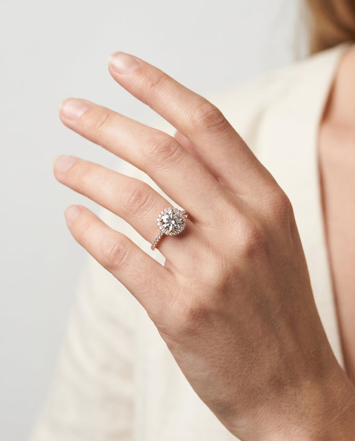 Dionne Select Diamond Pavé Halo Round Lab Diamond Engagement Ring in 14K Rose Gold, shown on hand | RockHer