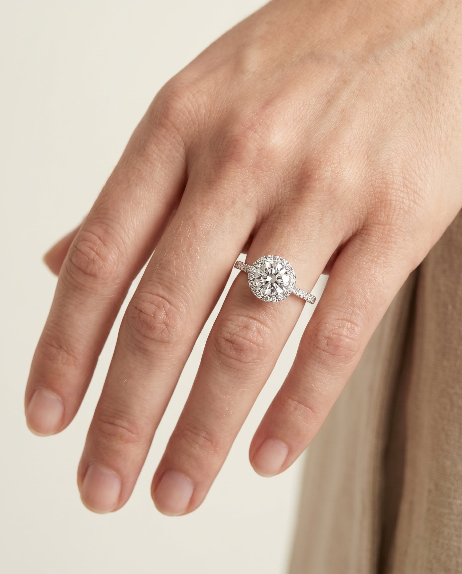 Dionne Select Diamond Pavé Halo Round Lab Diamond Engagement Ring in Platinum, shown on hand | RockHer