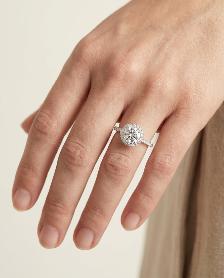 Dionne Select Diamond Pavé Halo Round Lab Diamond Engagement Ring in Platinum, shown on hand | RockHer