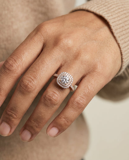 Dixie Select Double Halo Round Lab Diamond Engagement Ring in 14K Rose Gold, shown on hand, angled | RockHer