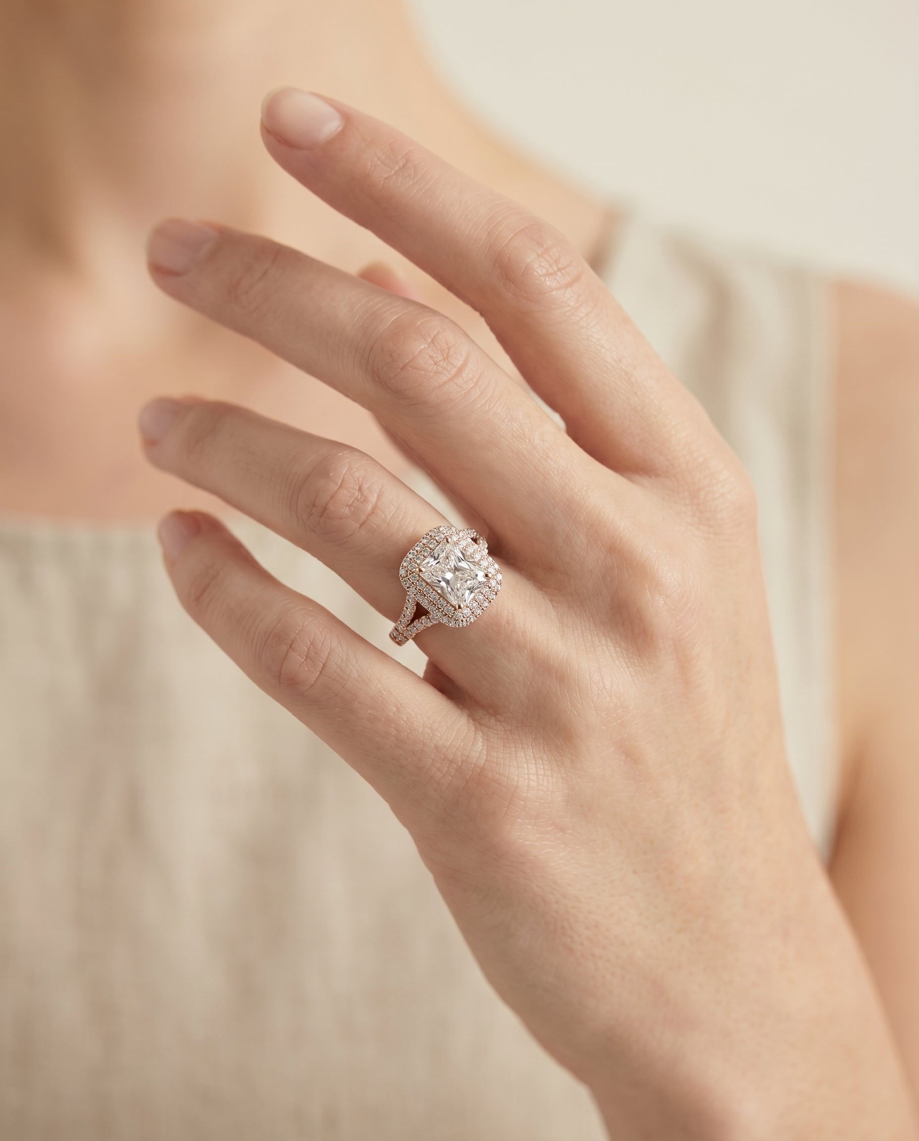 Betty Select Double Halo Radiant Cut Lab Diamond Engagement Ring in 14K Rose Gold, shown on hand, angled | RockHer