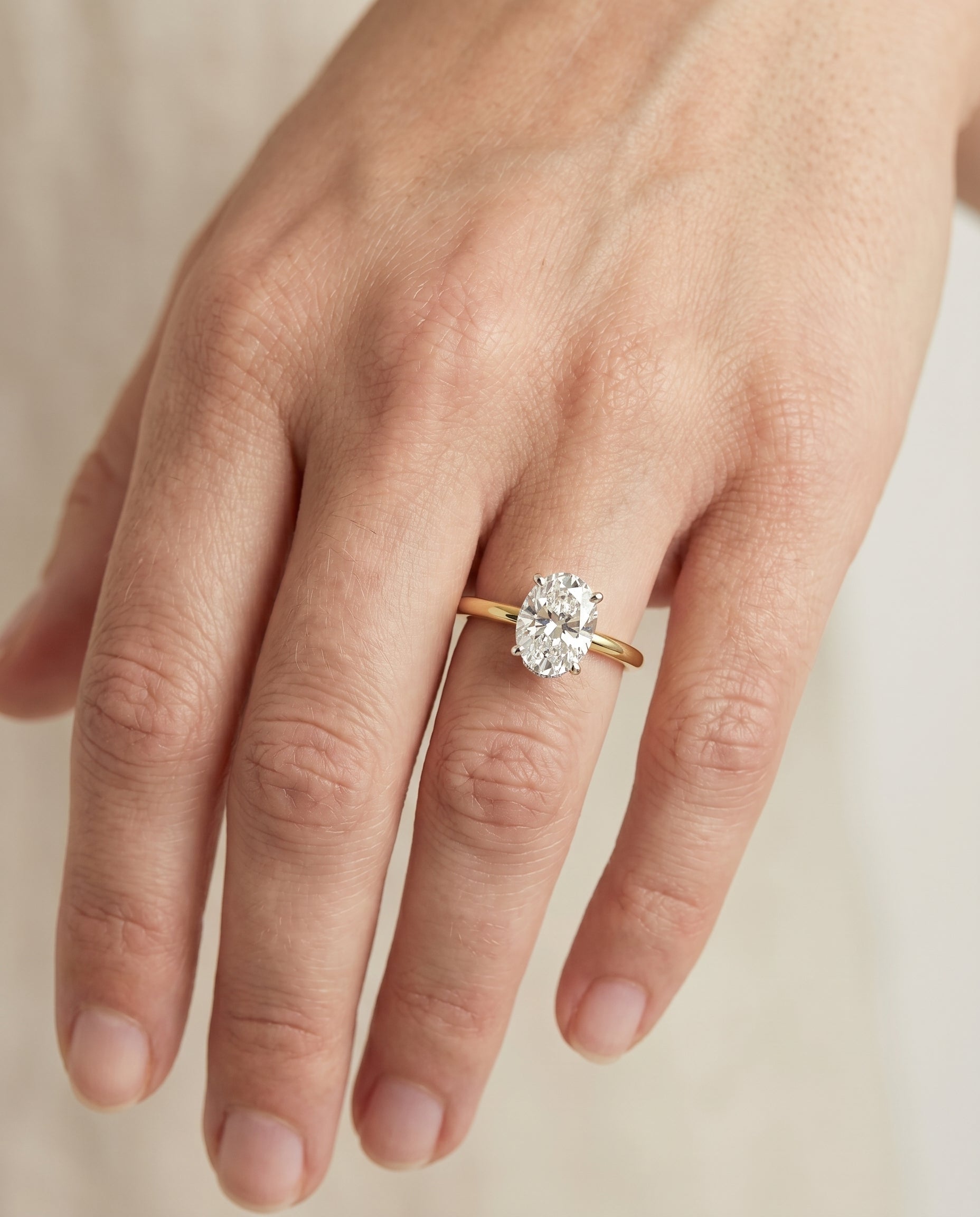 Dolly Select Double Hidden Halo Solitaire Oval Lab Diamond Engagement Ring in 18K Yellow Gold, shown on hand | RockHer