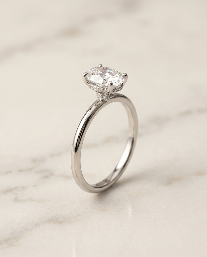 The Dolly Hidden Halo Solitaire Engagement Ring Setting for Oval Diamonds in 18K White Gold | RockHer