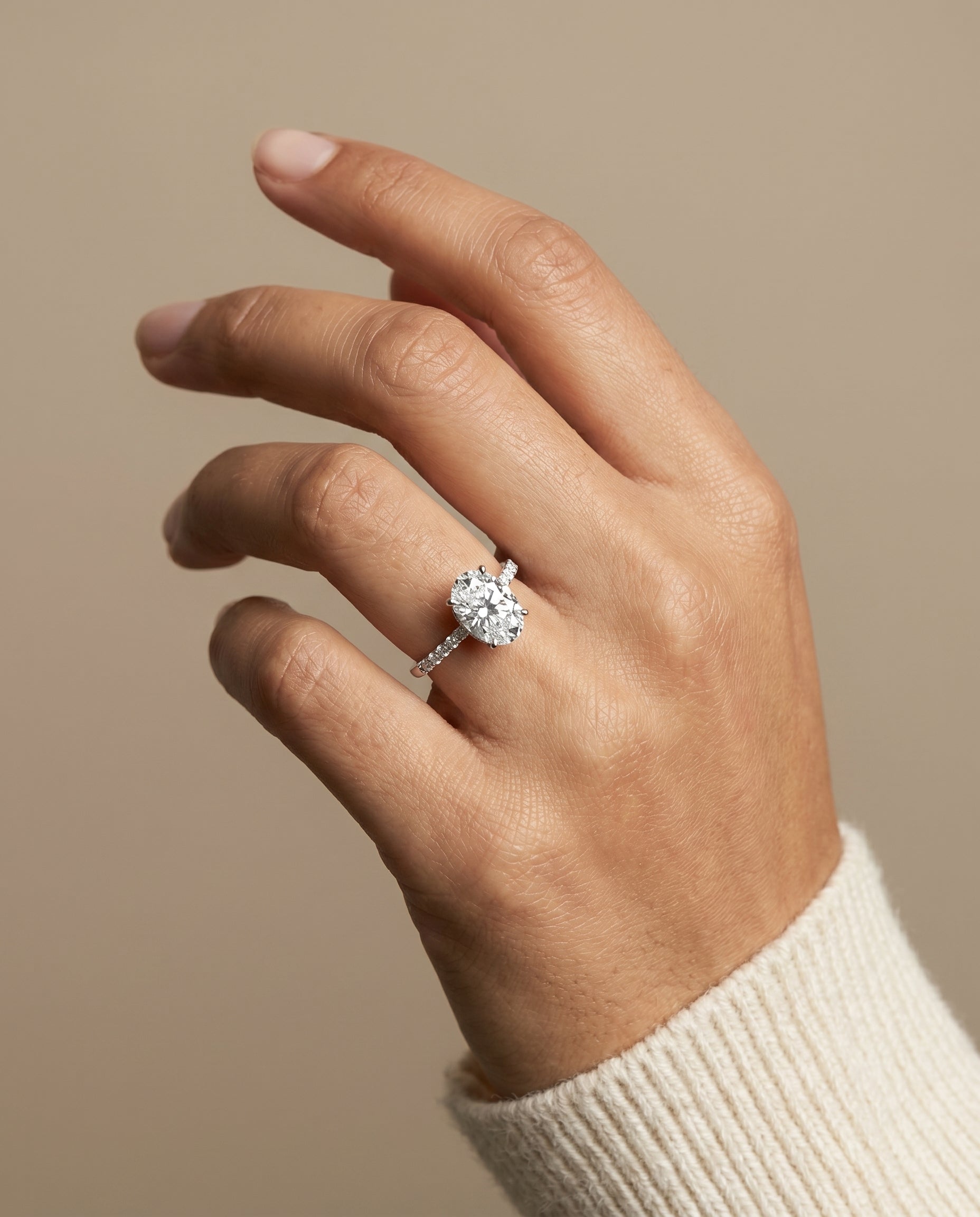 Abbey Select Hidden Halo Pavé Oval Lab Diamond Engagement Ring in 18K White Gold, shown on hand, angled | RockHer