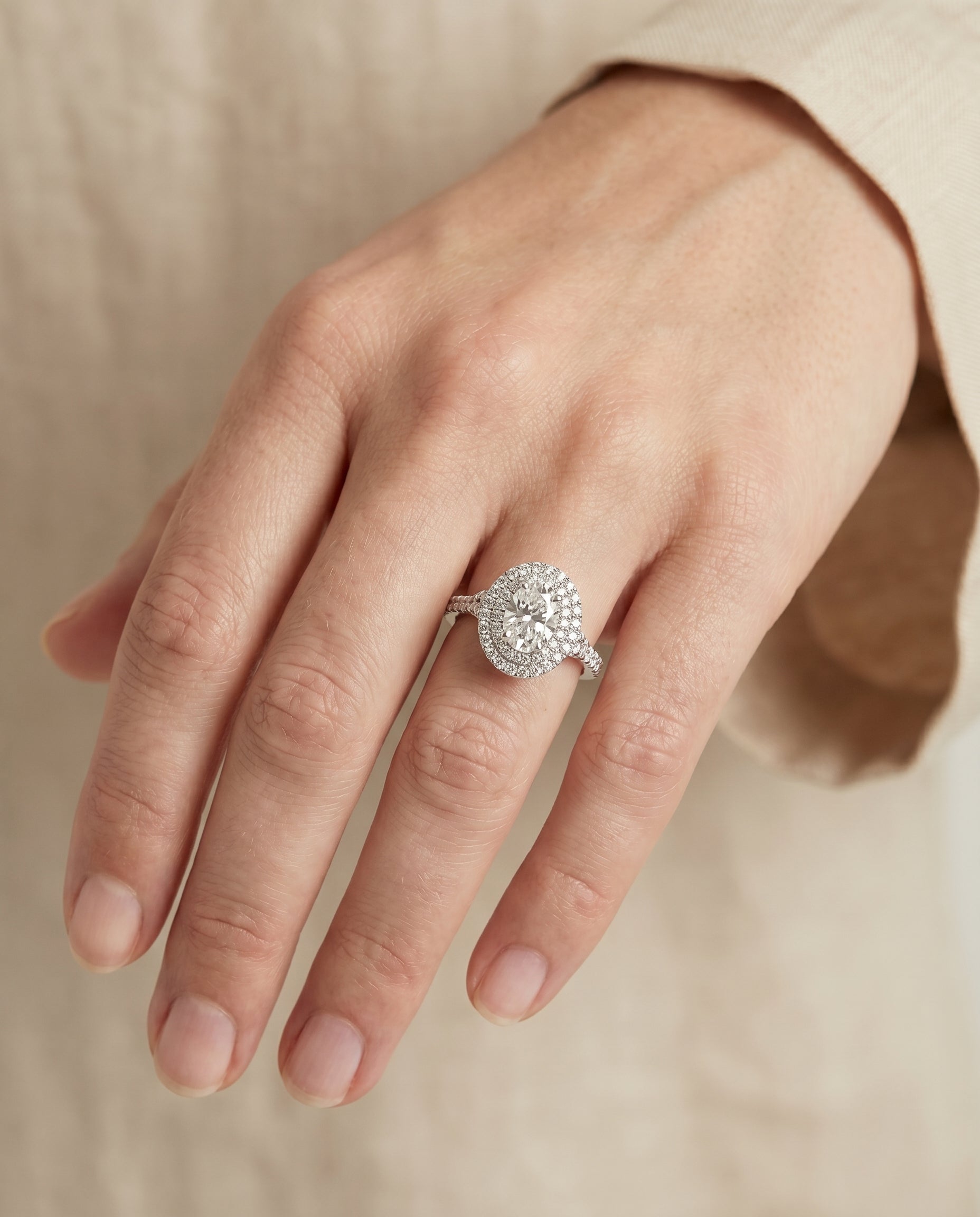 Britney Select Double Halo Oval Lab Diamond Engagement Ring in Platinum, shown on hand, angled | RockHer