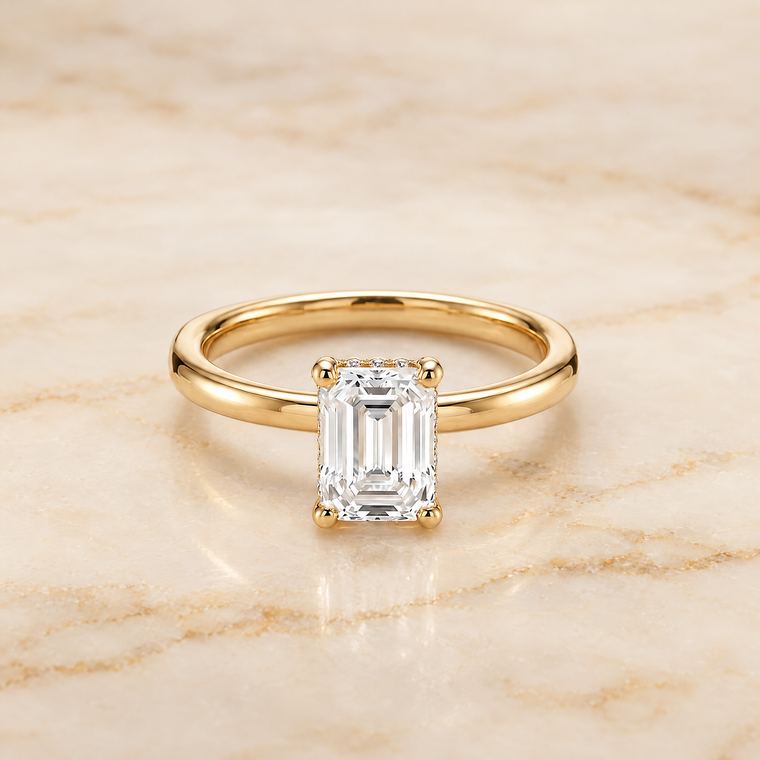 The Lana Secret Halo Adorned Prong Solitaire Emerald Cut Engagement Ring Setting in 18K Yellow Gold