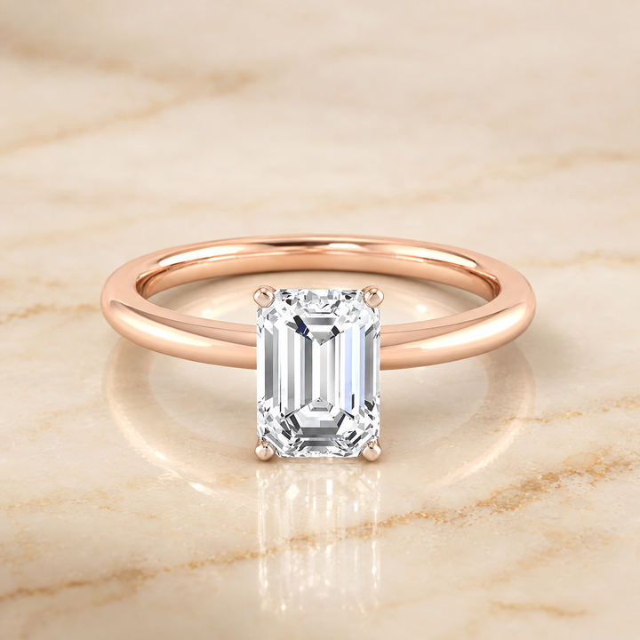 The Floria Comfort Fit Claw Prong Solitaire Emerald Cut Engagement Ring Setting in 14K Rose Gold