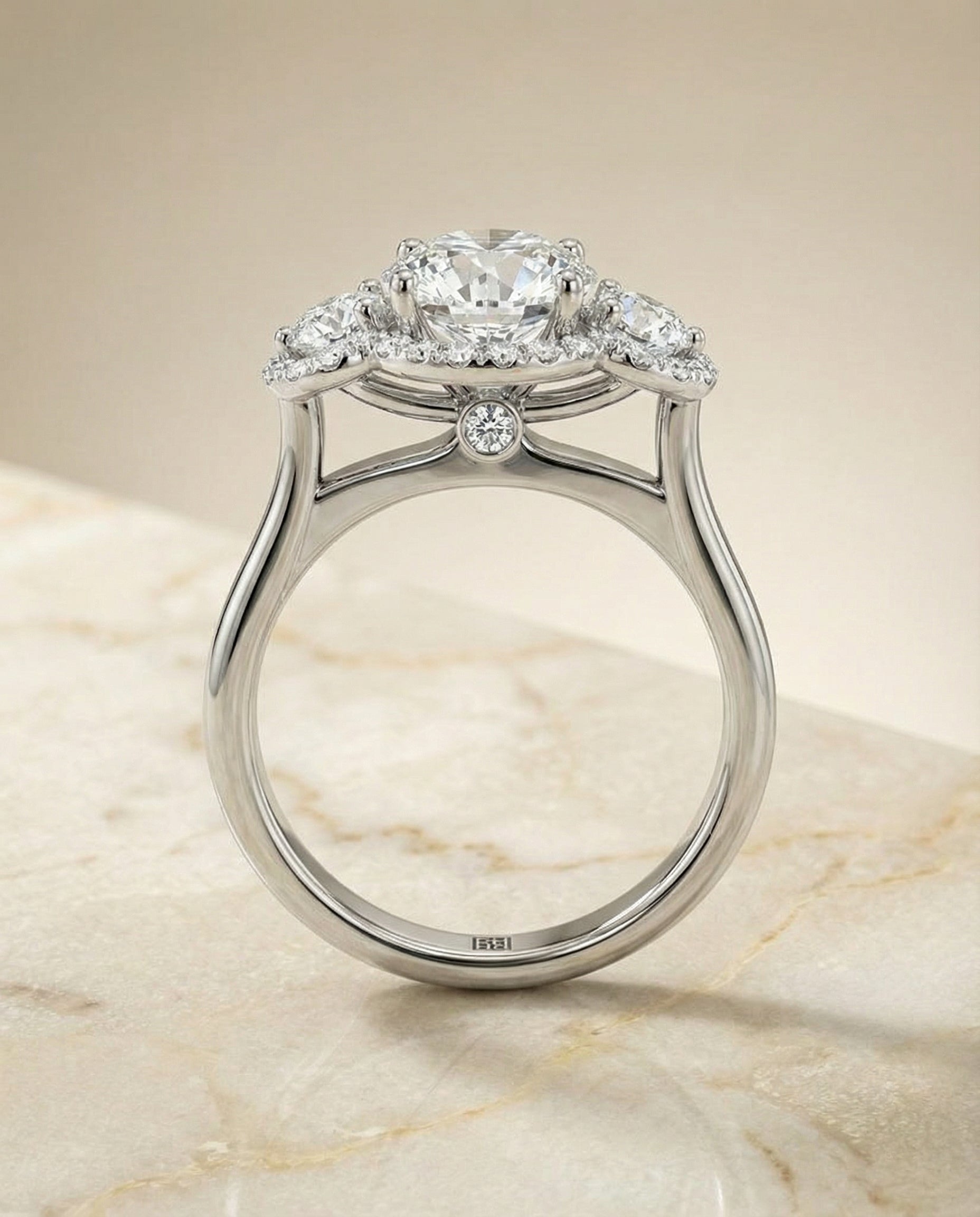 The Anna three stone halo engagement ring setting, shown in Platinum | RockHer