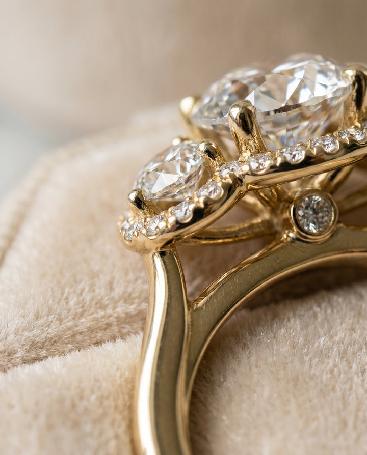 Round Brilliant, French Pavé Three Stone, in 18K Yellow Gold, prong setting – detail view | RockHer