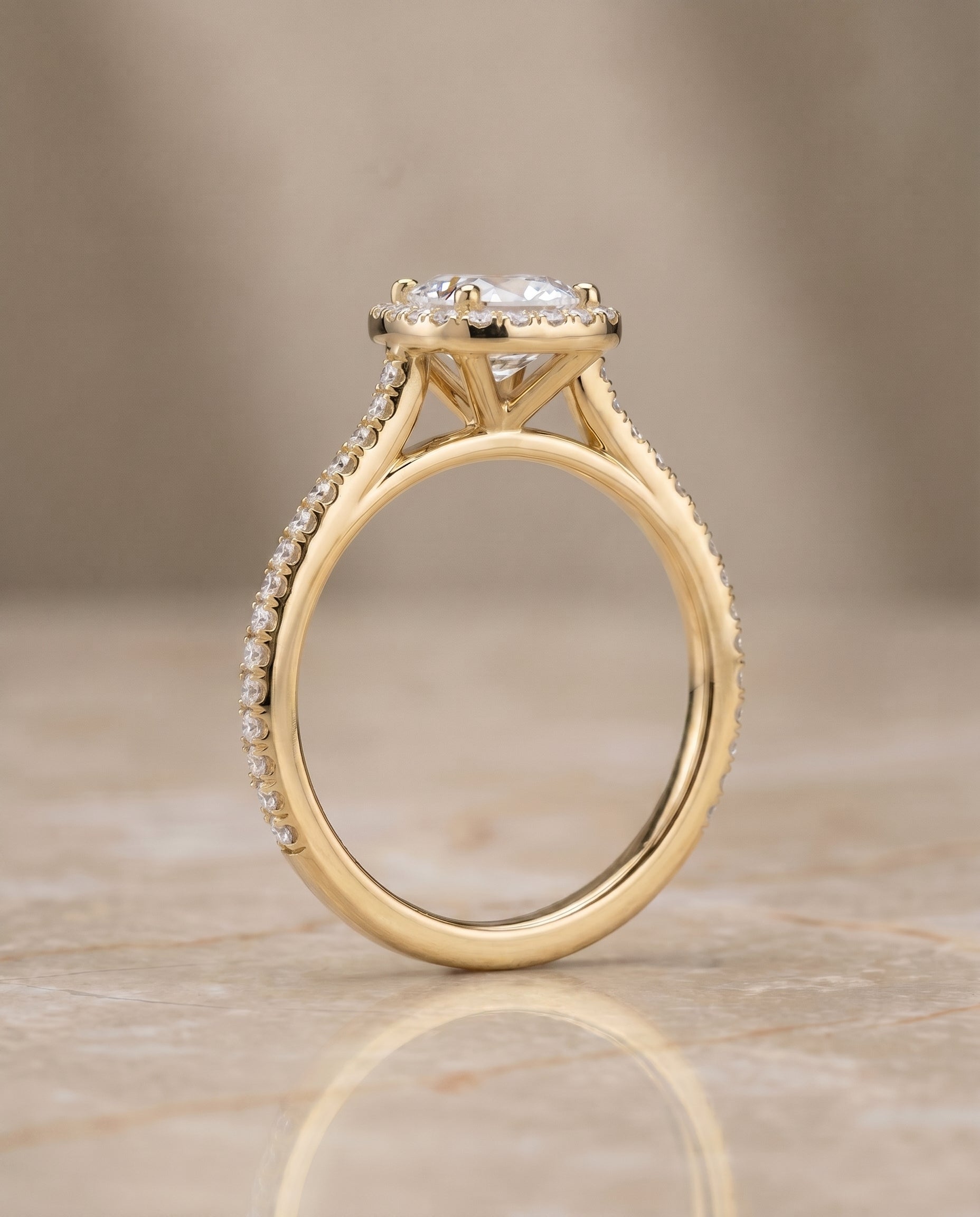 The Sonata graduated shank pavé halo cut engagement ring setting, shown in 18K Yellow Gold | RockHer