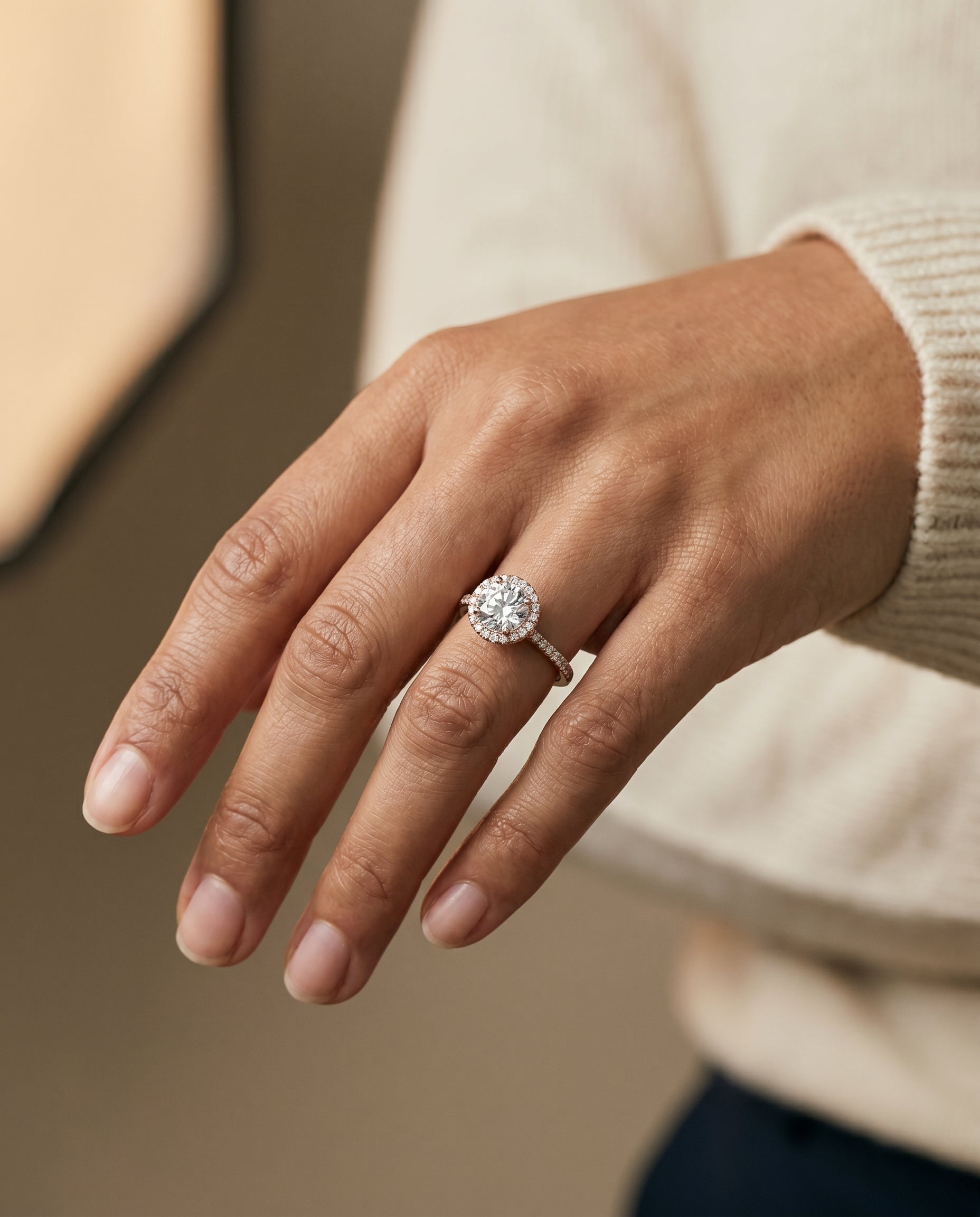 Sonata Select Graduated Shank Pavé Halo Round Lab Diamond Engagement Ring in 14K Rose Gold, shown on hand, angled | RockHer