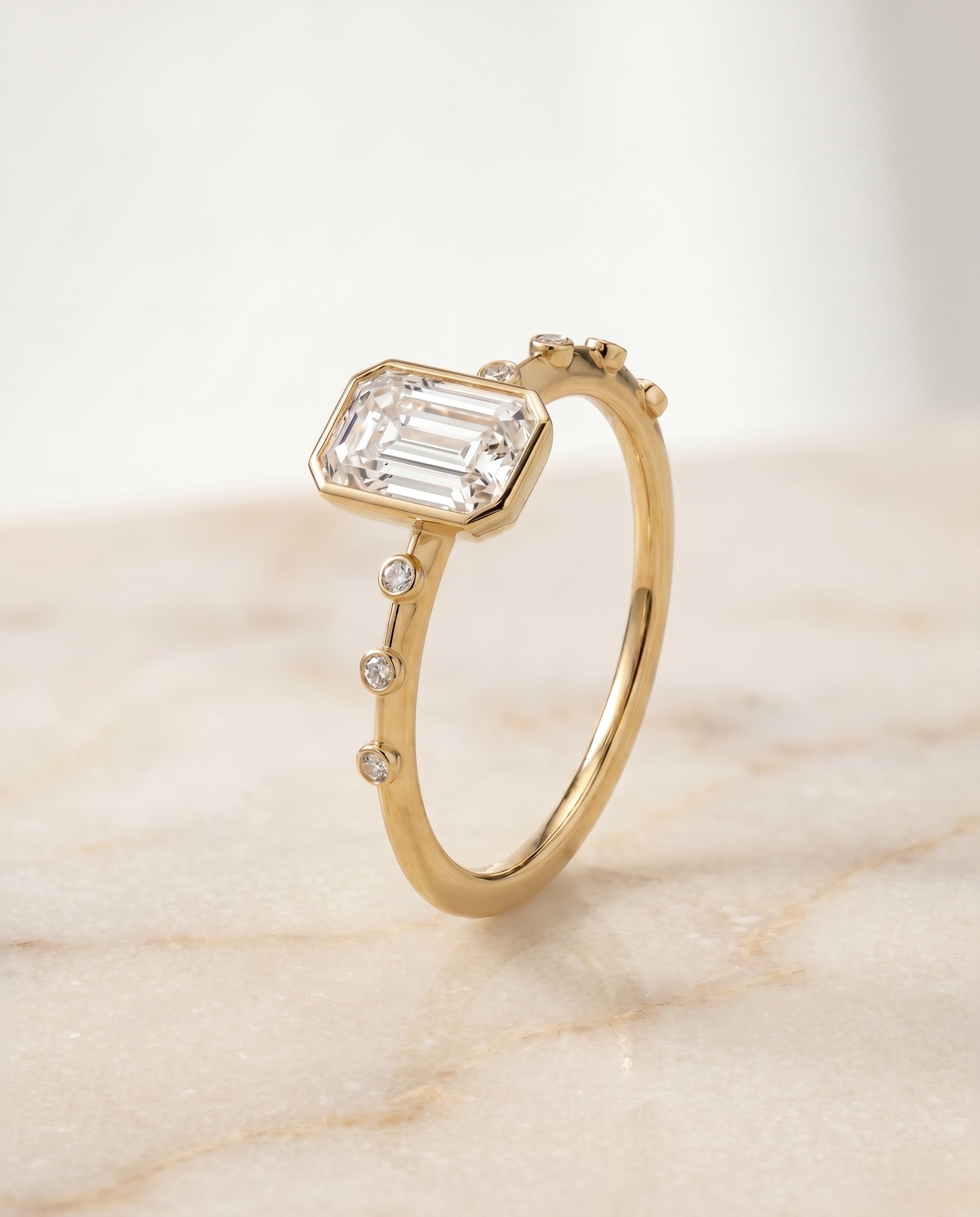The Brandi bezel accent solitaire engagement ring setting for emerald diamonds in 18k yellow gold engagement ring setting...