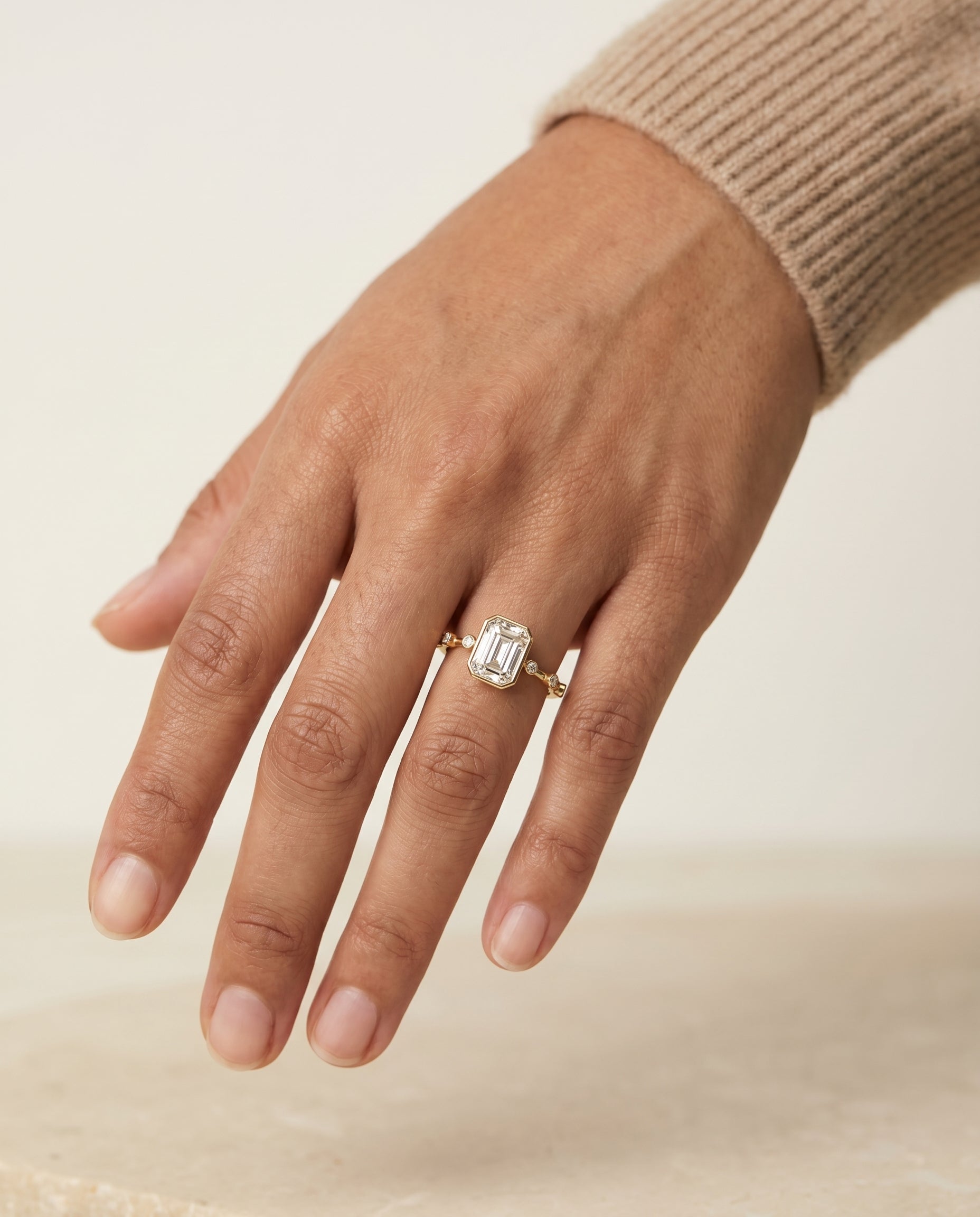The Brandi engagement ring setting in precious metal, bezel accent solitaire engagement ring setting for emerald diamonds...