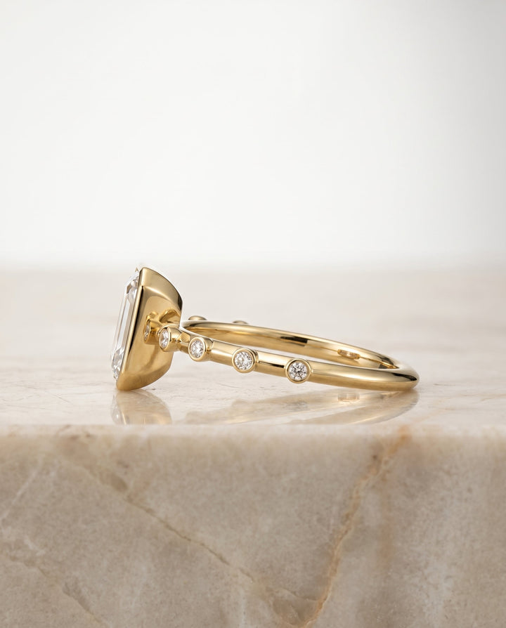 The Brandi Select Bezel Accent Solitaire Emerald Cut Engagement Ring with Lab Diamond in 14K Yellow Gold — view 2