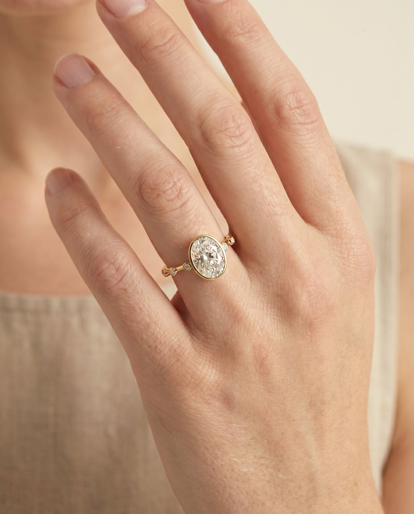 The Brandi Bezel Accent Solitaire Engagement Ring Setting for Oval Diamonds in 18K Yellow Gold