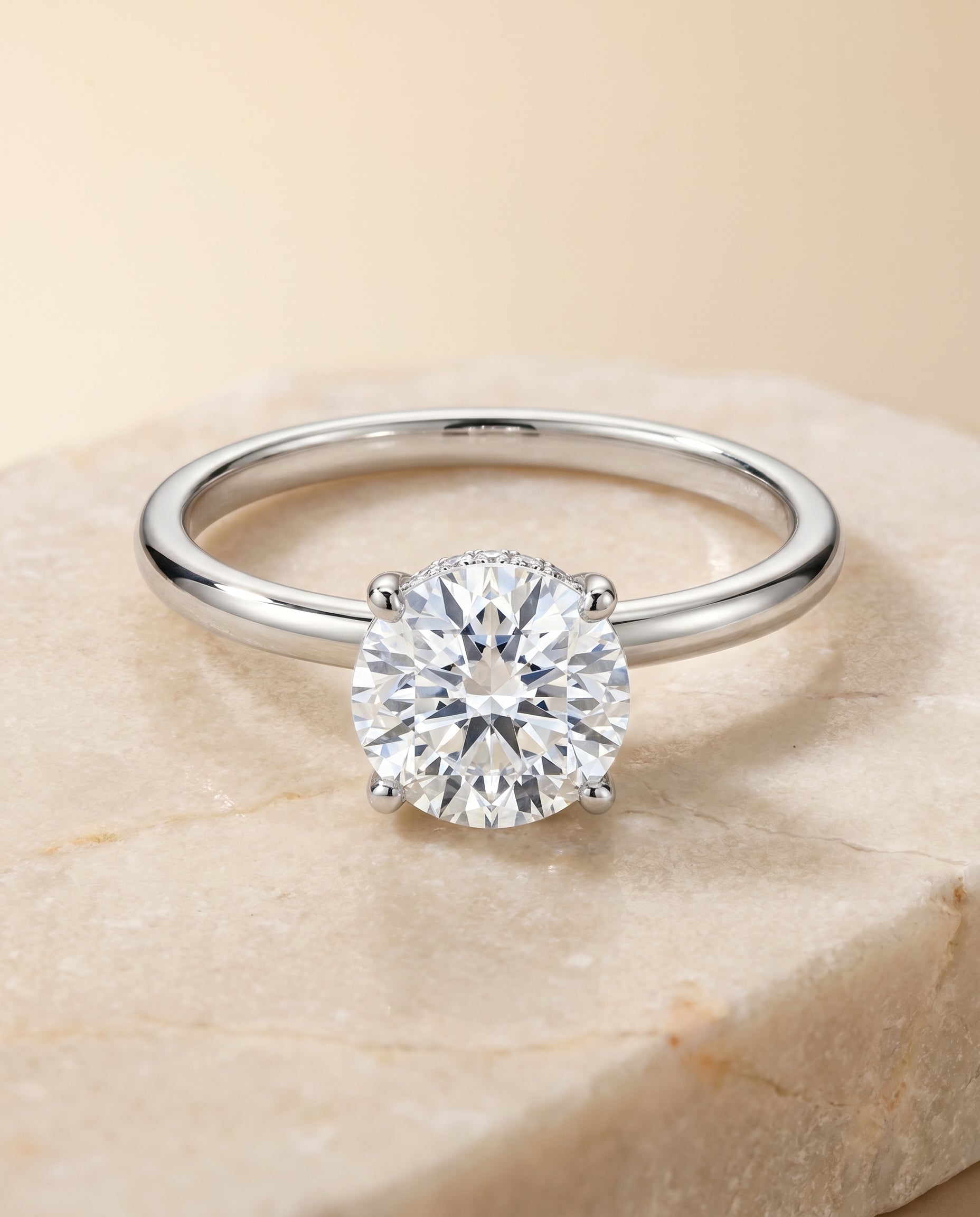 Joni Select Hidden Halo Solitaire Round Lab Diamond Engagement Ring in 18K White Gold, shown on hand, angled | RockHer