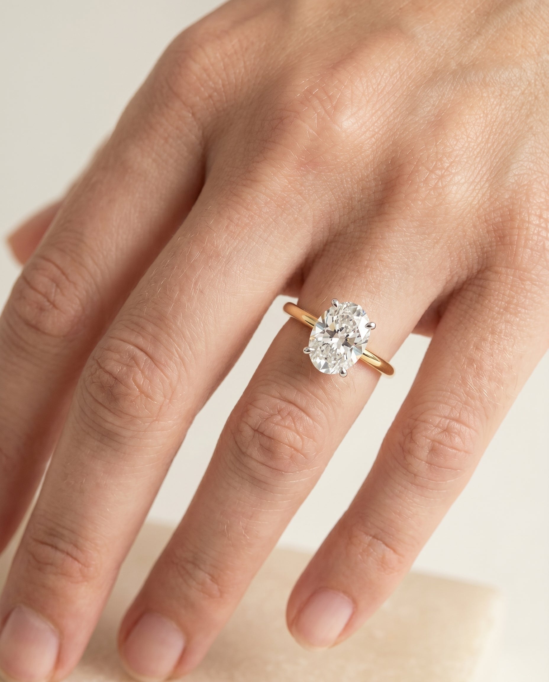 Joni Select Hidden Halo Solitaire Oval Lab Diamond Engagement Ring in 18K Yellow Gold, shown on hand | RockHer
