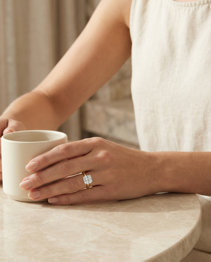 Hidden Pavé Basket Crown Solitaire Cushion, in 18K Yellow Gold – lifestyle shot | RockHer