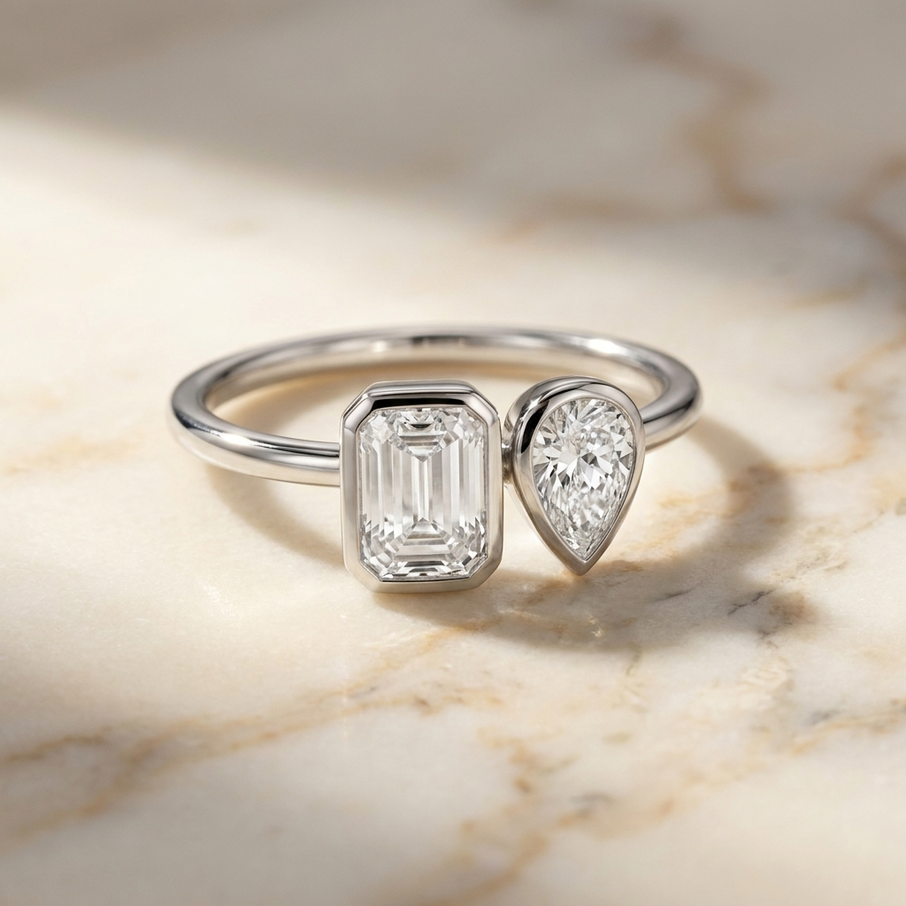 14K White Gold Josephine Select Toi et Moi Emerald & Pear Bezel Set Lab Diamond Engagement Ring - Hero on warm marble