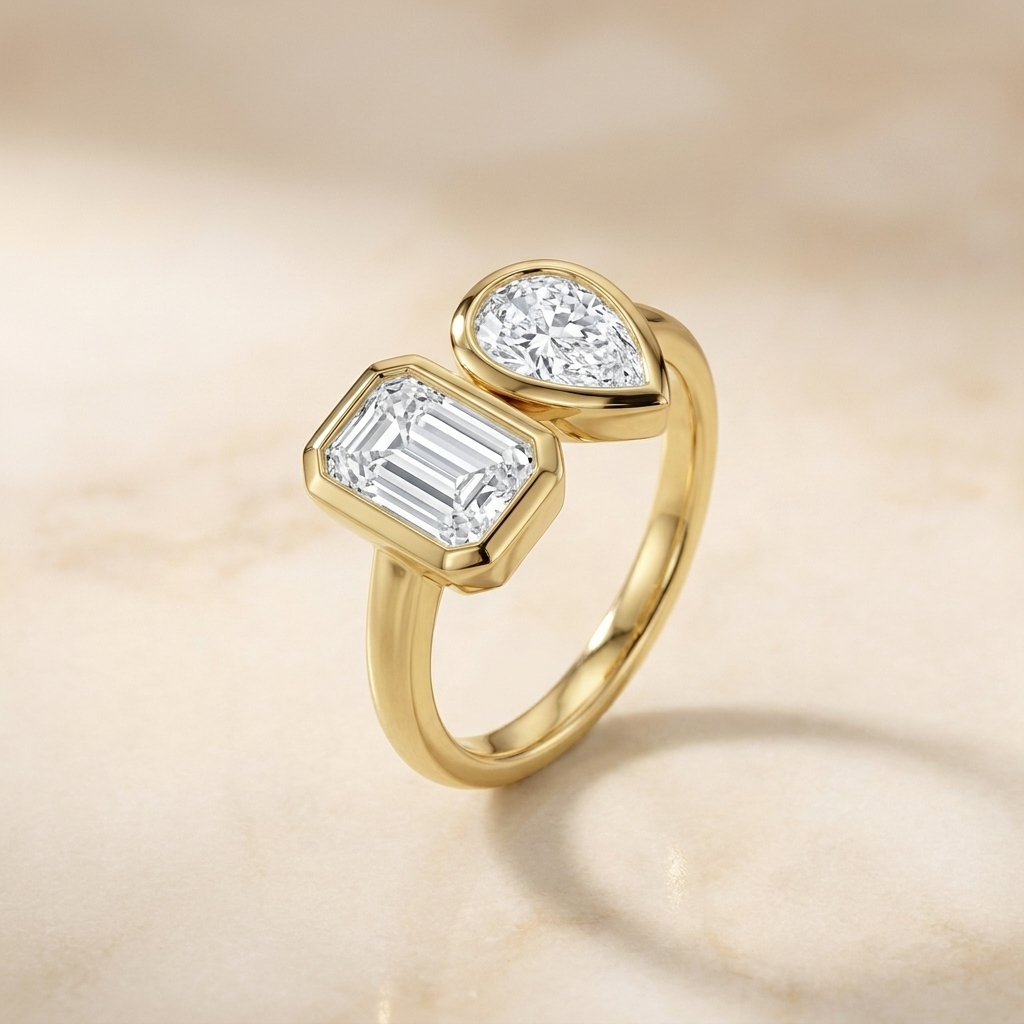 14K Yellow Gold Josephine Select Toi et Moi Emerald & Pear Bezel Set Lab Diamond Engagement Ring - Alt angle on warm marble