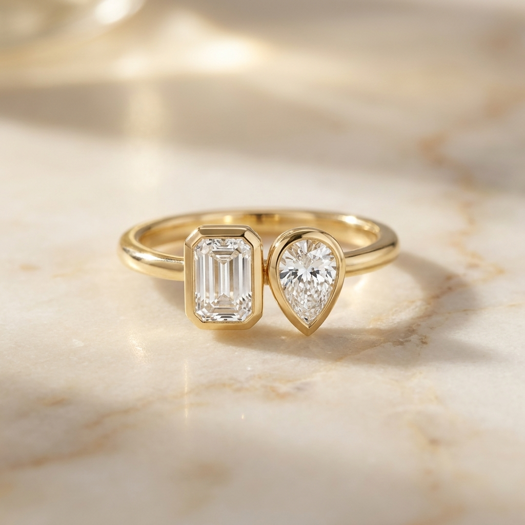 14K Yellow Gold Josephine Select Toi et Moi Emerald & Pear Bezel Set Lab Diamond Engagement Ring - Hero on warm marble