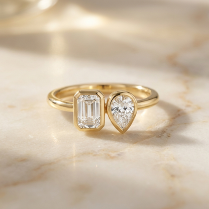 14K Yellow Gold Josephine Select Toi et Moi Emerald & Pear Bezel Set Lab Diamond Engagement Ring - Hero on warm marble