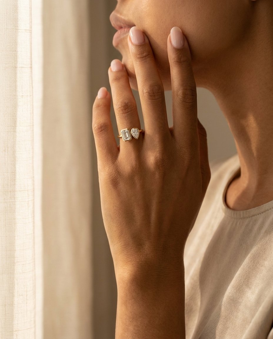 14K Yellow Gold Josephine Select Toi et Moi Emerald & Pear Bezel Set Lab Diamond Engagement Ring - Lifestyle scene with hand model