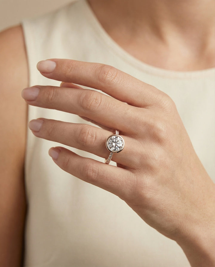 Cappella Select linear bezel pavé round ring in 14K Rose Gold — on hand angled — RockHer