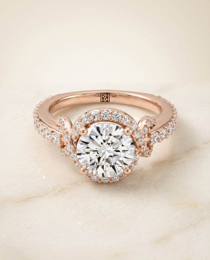 Bess Select Love Knot Pavé Halo Round Lab Diamond Engagement Ring in 14K Rose Gold, alternate angle | RockHer