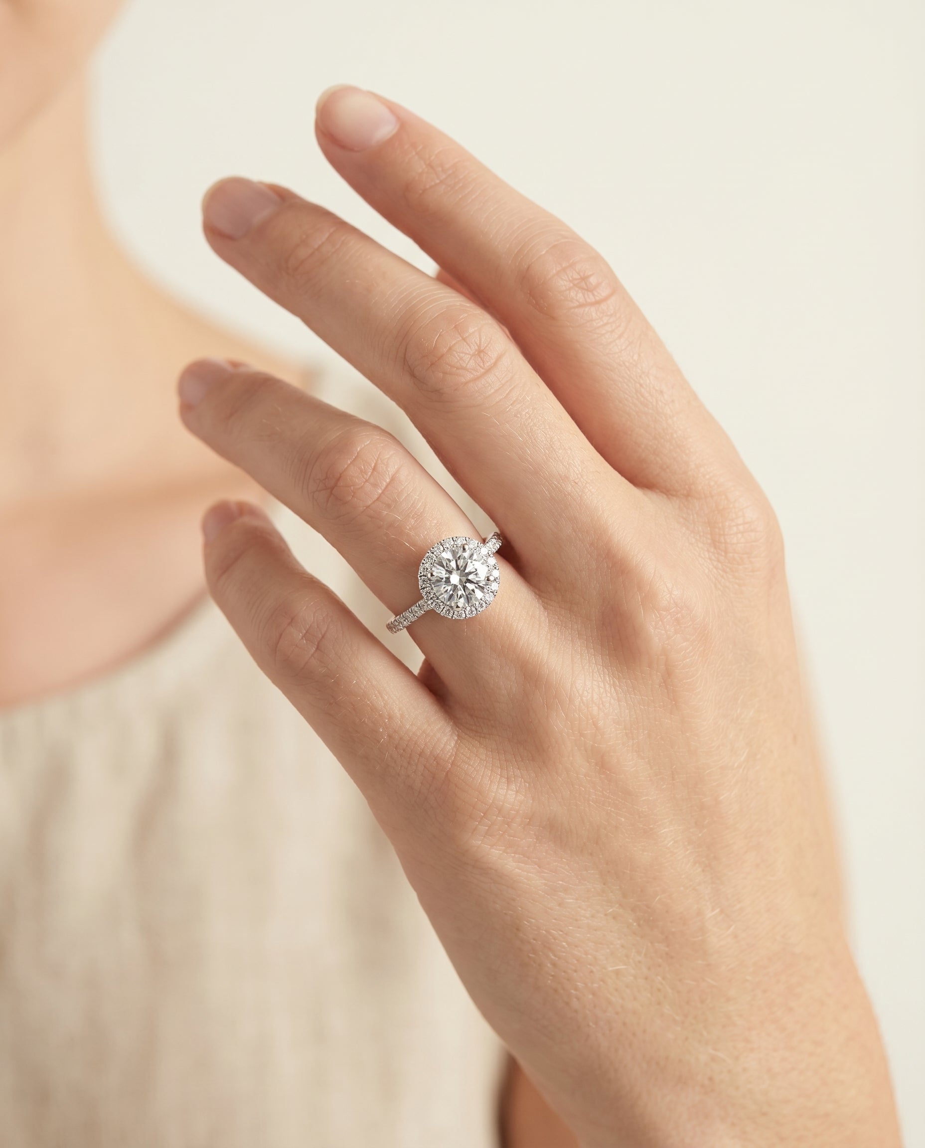 Dylan Select Petite French Pavé Halo Round Lab Diamond Engagement Ring in Platinum, shown on hand | RockHer