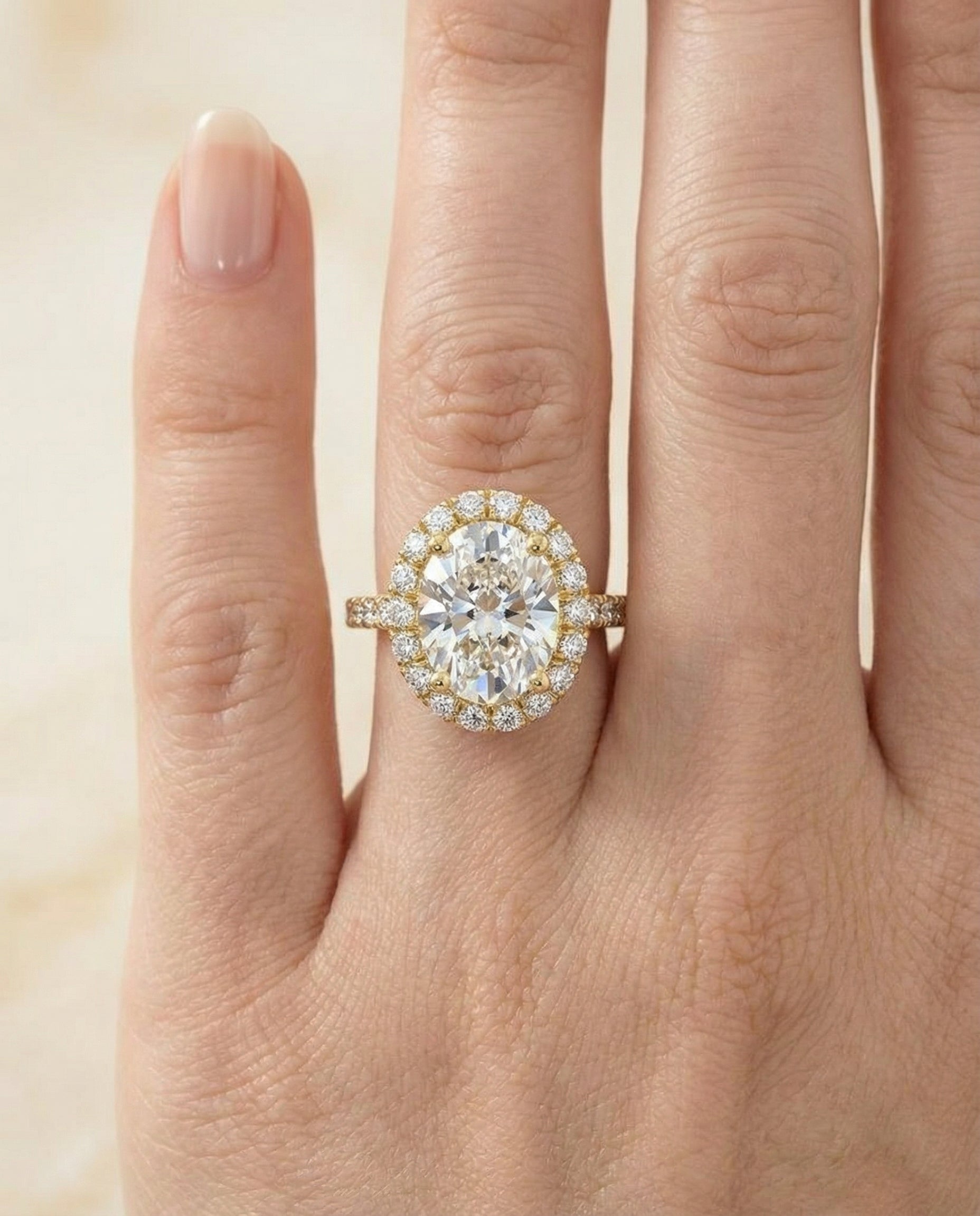 Dylan Select Petite French Pavé Halo Oval Lab Diamond Engagement Ring in 18K Yellow Gold, shown on hand | RockHer