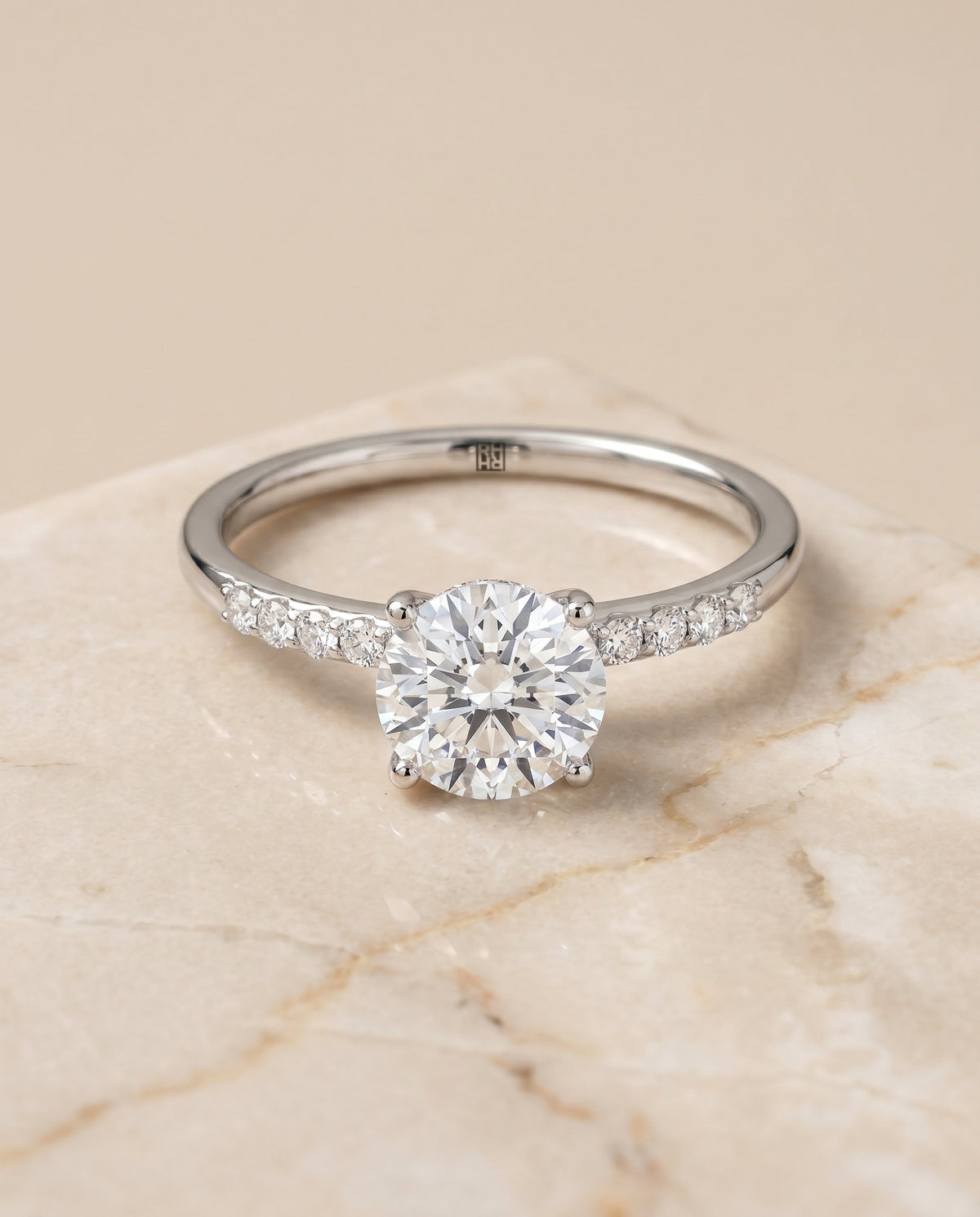 Cherie Select Hidden Halo Pavé Solitaire Round Lab Diamond Engagement Ring in Platinum, shown on hand, angled | RockHer